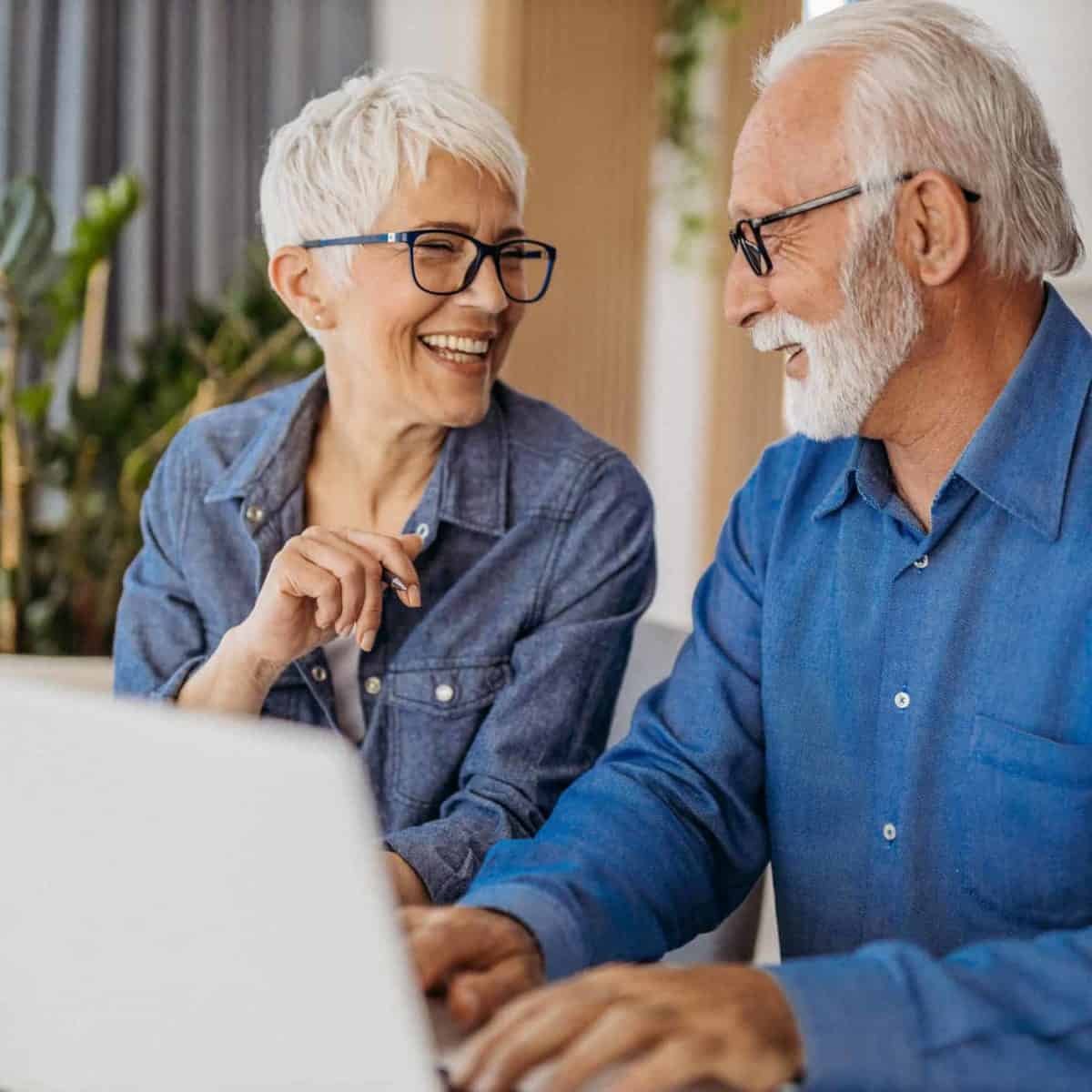 Auburn Precious Metals IRA & Investing Company Copy of Senior couple at laptop smiling GettyImages 1323096524 1200x1200 1